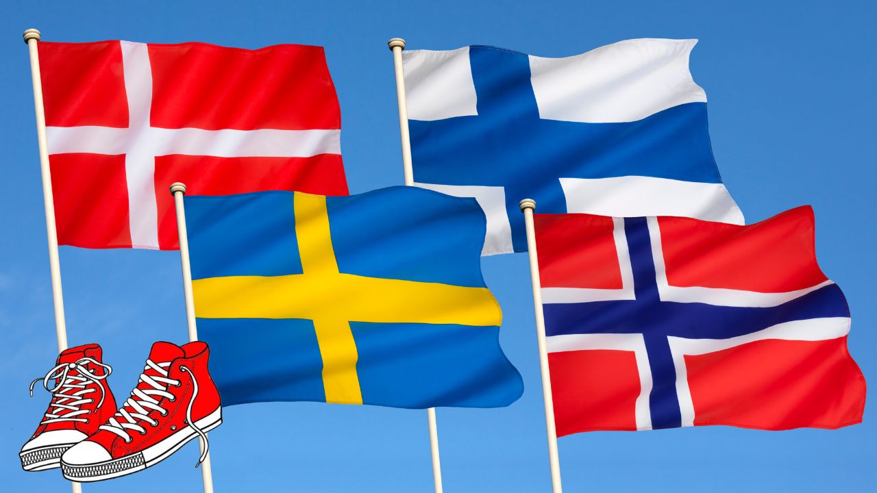 Die Flaggen der nordischen Länder Dänemark, Finnland, Schweden und Norwegen wehen im Wind, und ein Paar rote Turnschuhe symbolisiert die Fetalen Alkohol-Spektrumstörungen (FASD).
